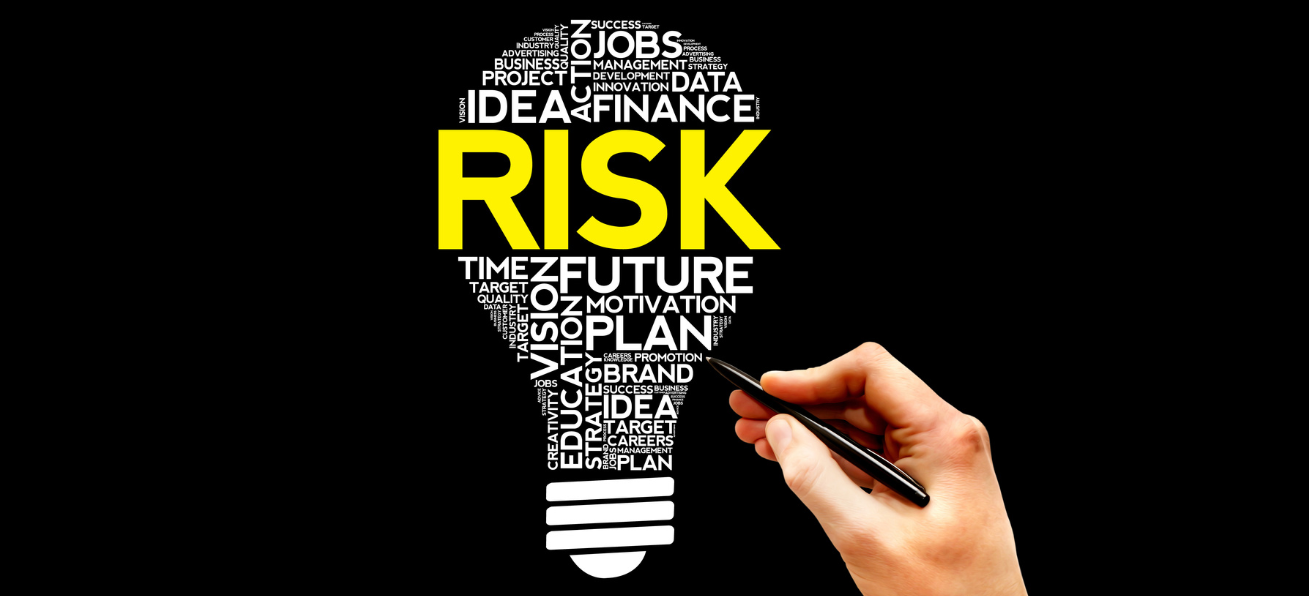 hand with word cloud on the theme of risk in the shape of a lightbulb